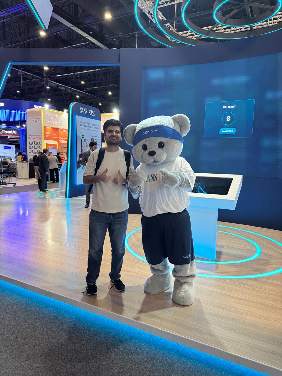 Haseeb Sultan with the SANS and GIAC mascot on the GISEC Global exhibition floor.